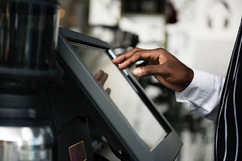 man touching screen of monitor