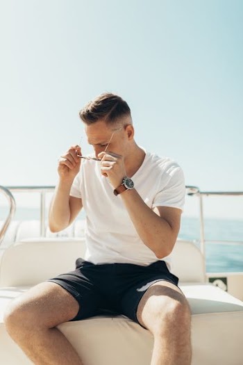 man trying to wear sunglasses