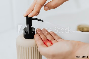 Man using a soap dispenser