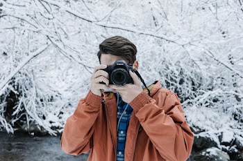 man using black DSLR camera