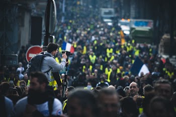 Man Using Camera Between Crowd