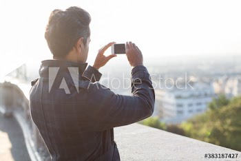 Man using camera phone, Montmartre, Paris, France