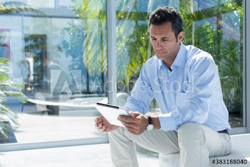 Man using digital tablet on sunny patio