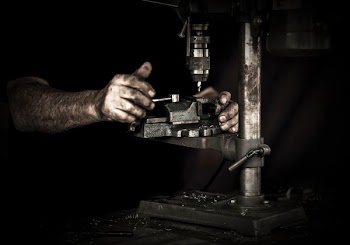man using drill press