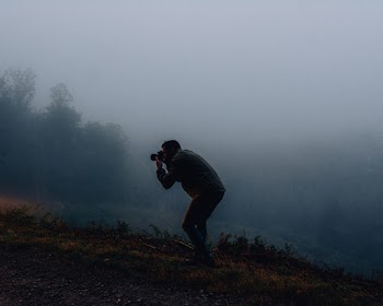 Man Using Dslr Camera on a Foggy day