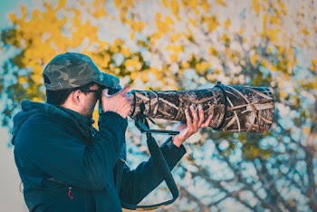 Man Using Gray and Black Dslr Camera With Telephoto Lens