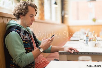 Man using smart phone in cafe