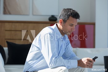 Man using smart phone on patio