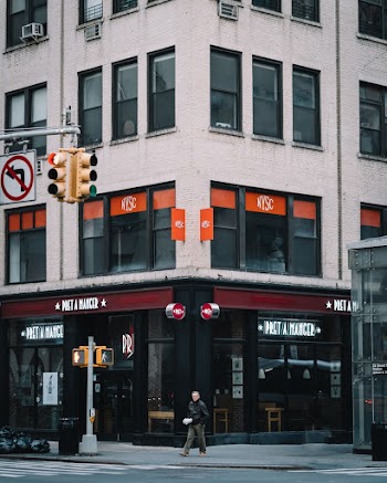 Man Walking Beside Building
