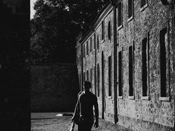Man Walking Beside Concrete Wall