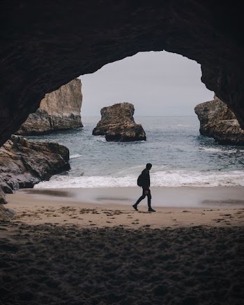 man walking beside shore