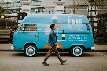 man walking beside van near concrete house