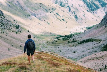 Man walking between mountains