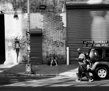 Man Walking By The Sidewalk