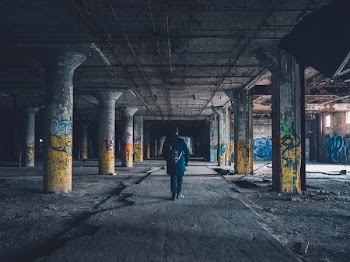 man walking hallway during daytime