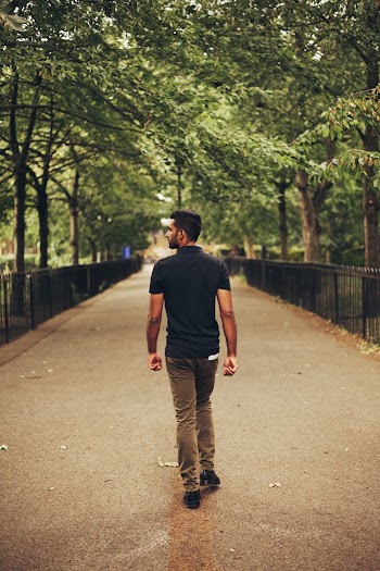 Man Walking in Middle of Pathway