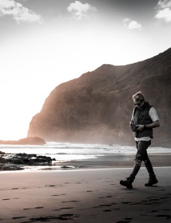 Man Walking Near Beach Line