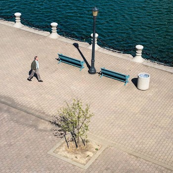 man walking near body of water during day