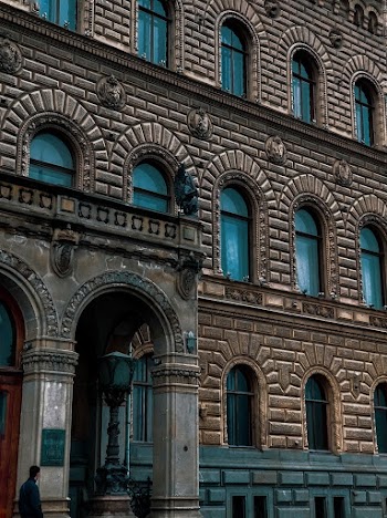 Man Walking Near Entrance of Building