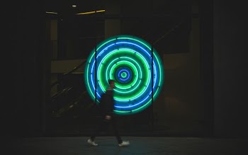 man walking near neon signage