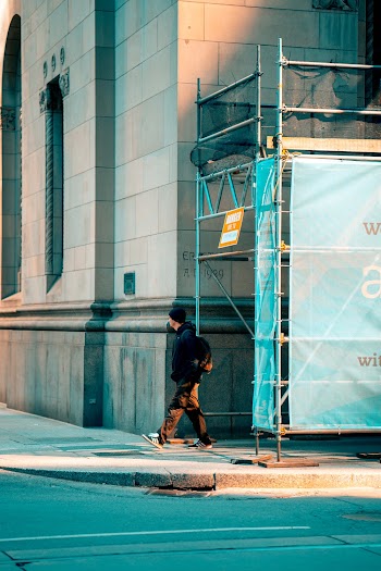 Man Walking Near Scaffolding