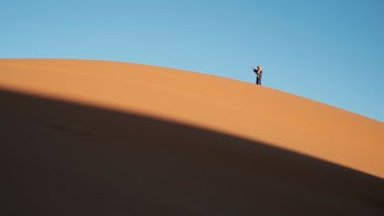 man walking on desert