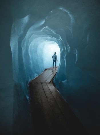 man walking on dock inside cave