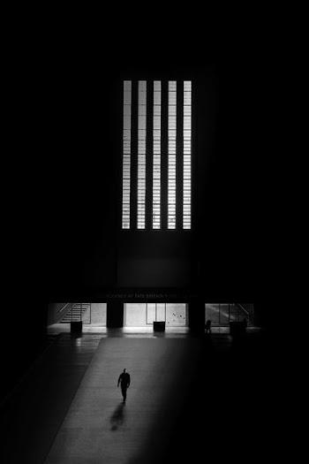 man walking on gray flooring