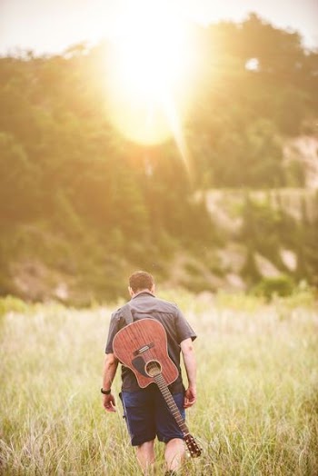 man walking on green grass field during daytime