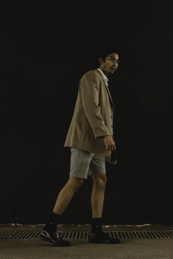 Man Walking on Pavement