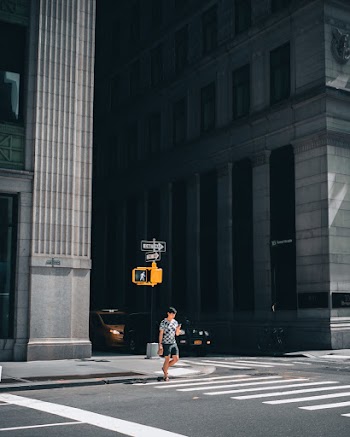 Man Walking on Pedestrian Lane