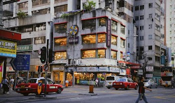 man walking on road near building