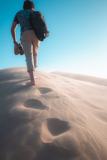 Man Walking on Sand