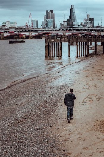 man walking on seashore