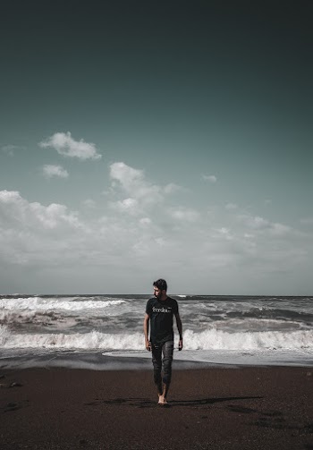 Man Walking on Shore