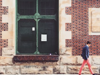 Man Walking On Sidewalk