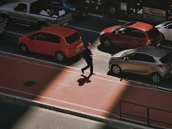 Man Walking on Sidewalk