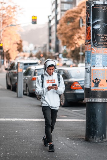 Man Walking on Sidewalke