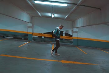 man walking on slope parking lot