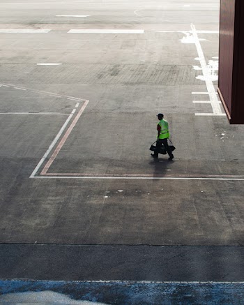 man walking on tarmac