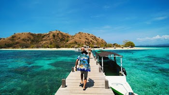 Man Walking on Wooden Dock