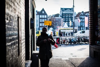 Man Walking Through an Alley