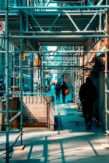 Man Walking Under Scaffolding