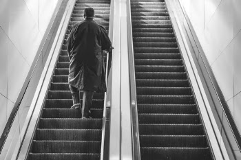 Man Walking Up Escalator Free Photo 