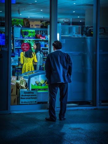 man watching the store from the outside