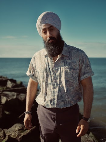Man Wearing a Turban Standing Near Body of Water