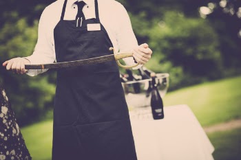 Man Wearing Apron Holding Sword