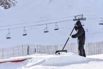 Man Wearing Back Jacket Shoveling the Snow