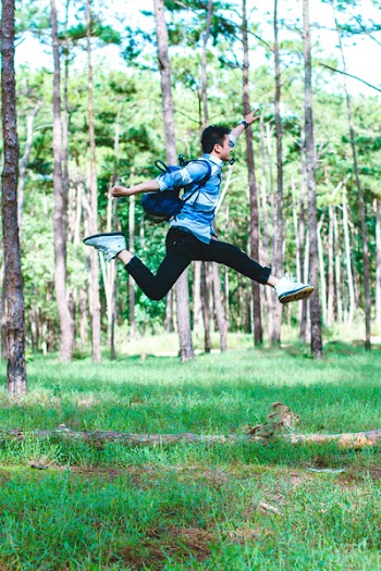 Man Wearing Backpack Jumping Photo