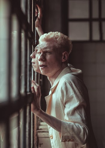 Man Wearing Beige Dress Shirt Beside Window